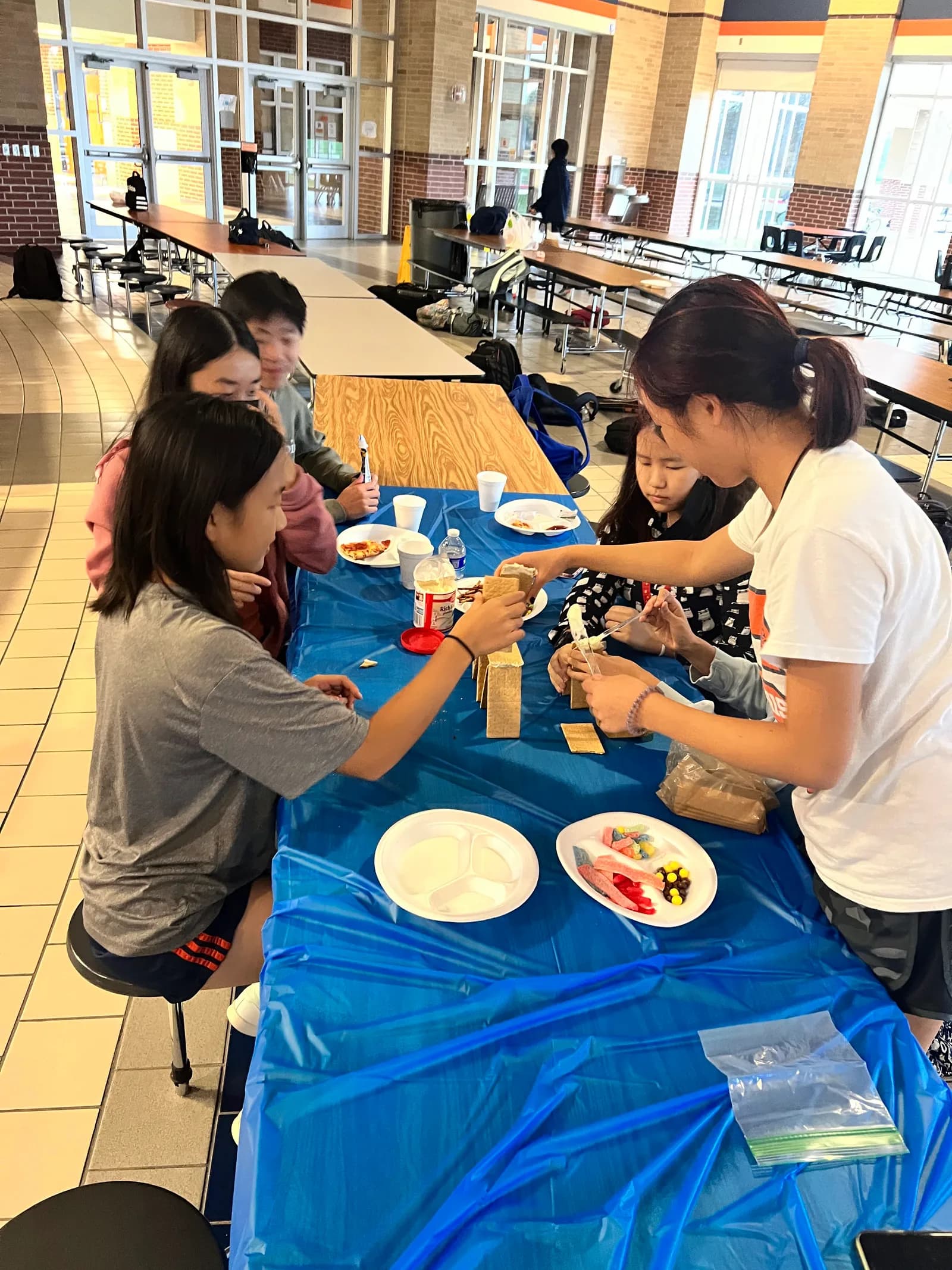Members leaning in to finish their candy build
