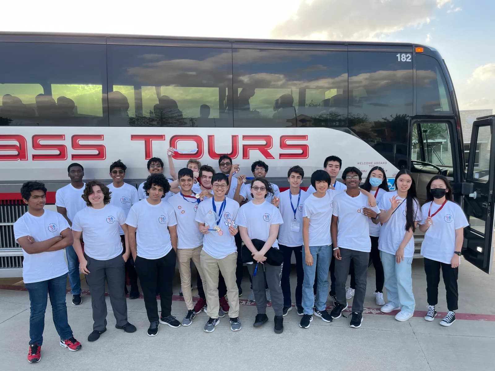 Chapter group photo in front of the First Class Tours bus