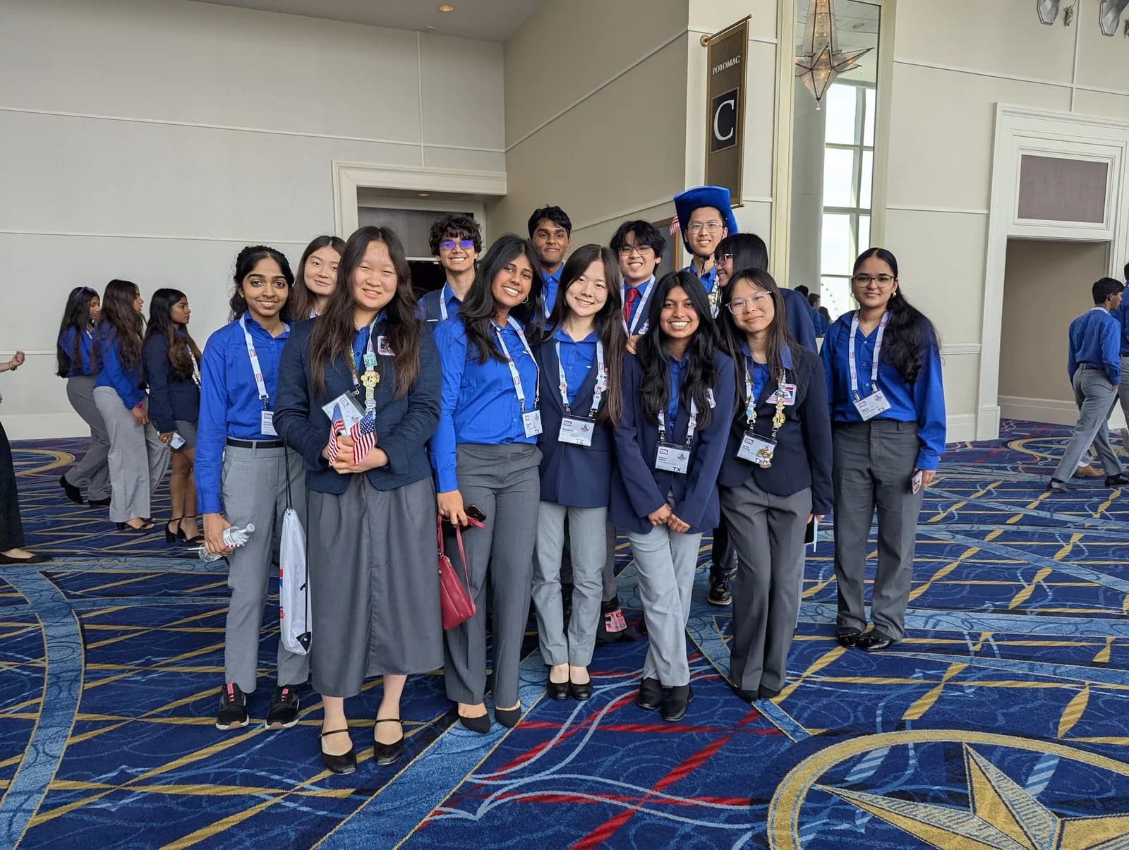 The full SLHS TSA delegation in blue competition shirts gathered in the convention center hallway