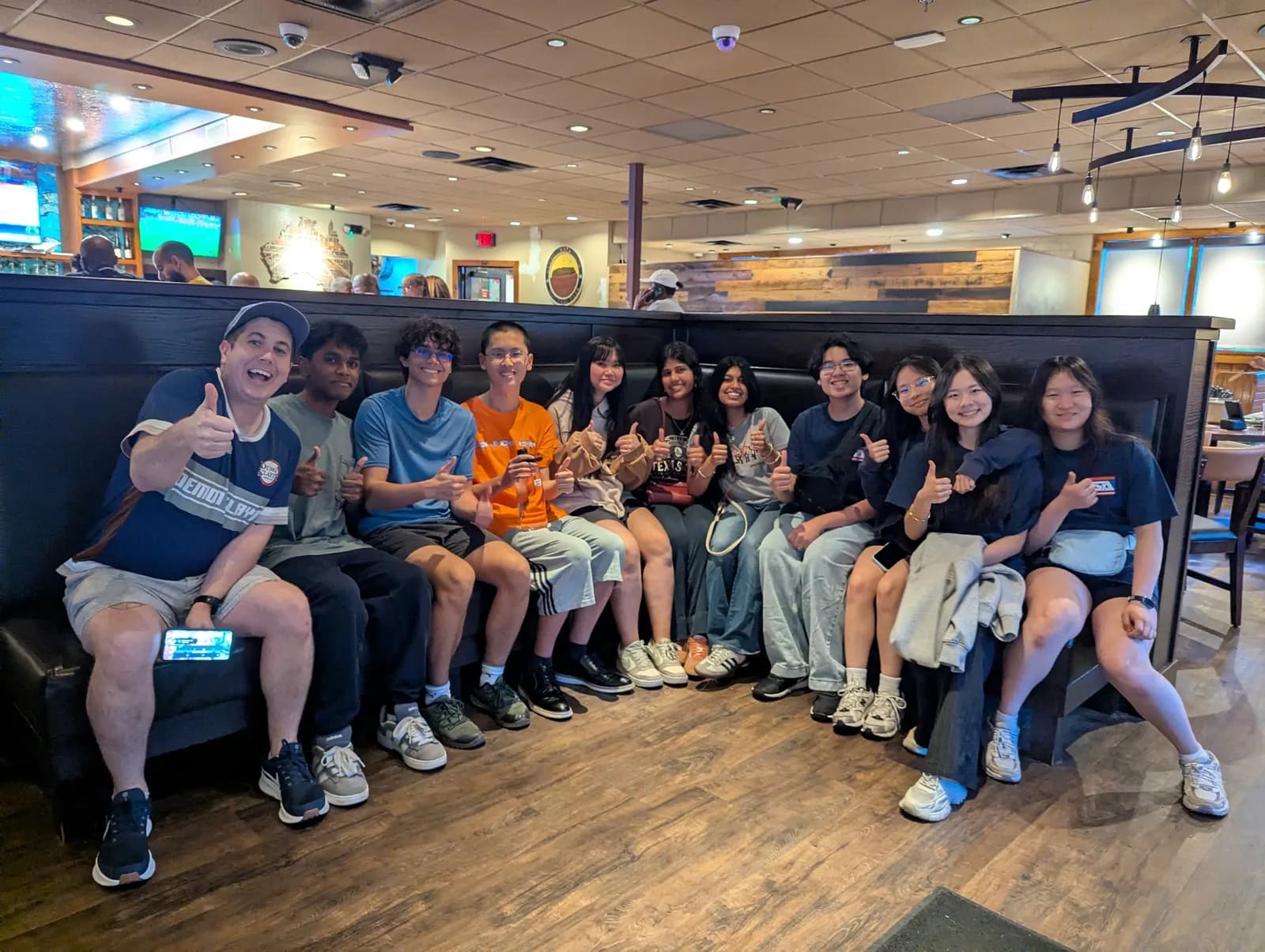 The whole SLHS TSA delegation packed into a big restaurant booth for a team dinner at the 2026 National TSA Conference