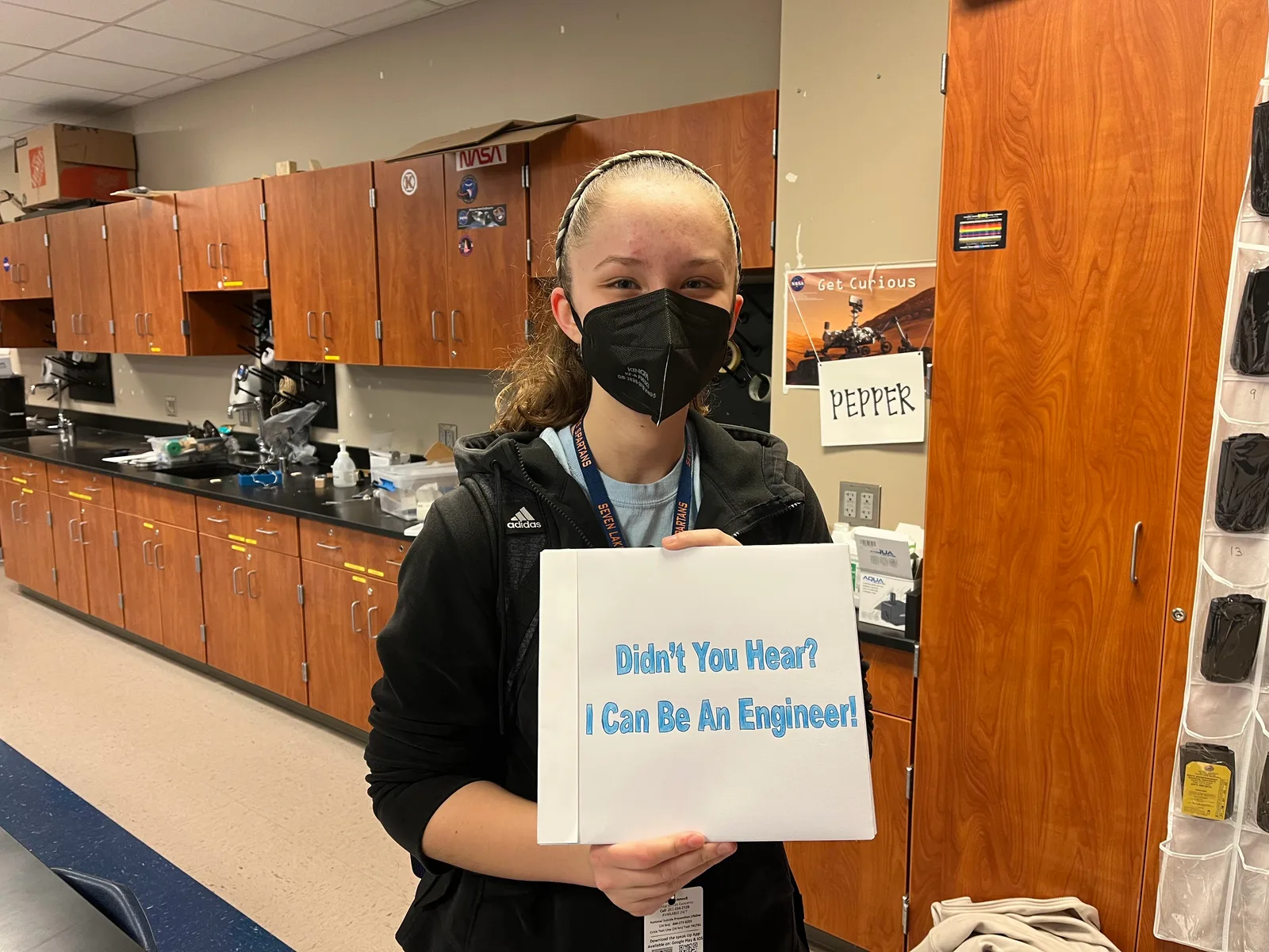 Member holding a binder reading 'Didn't You Hear? I Can Be An Engineer!'