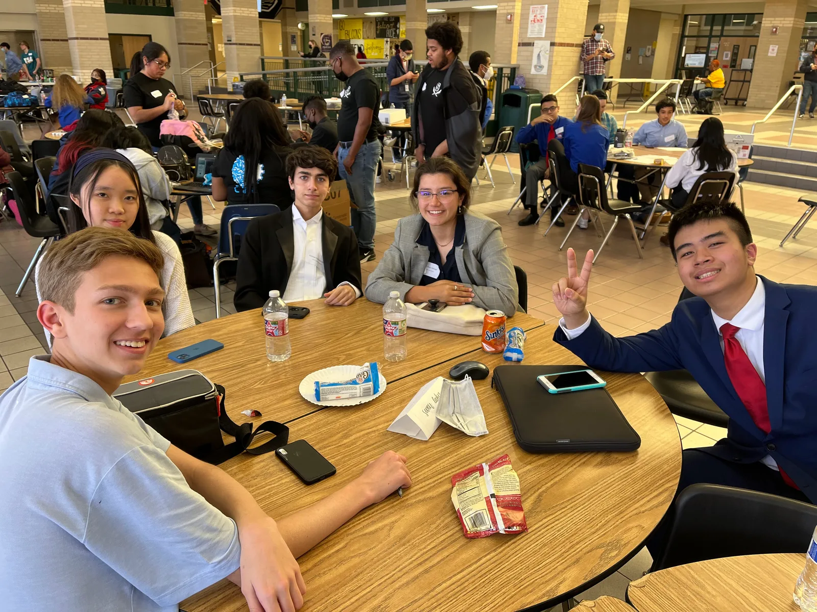 Members around a table during a break at Regionals