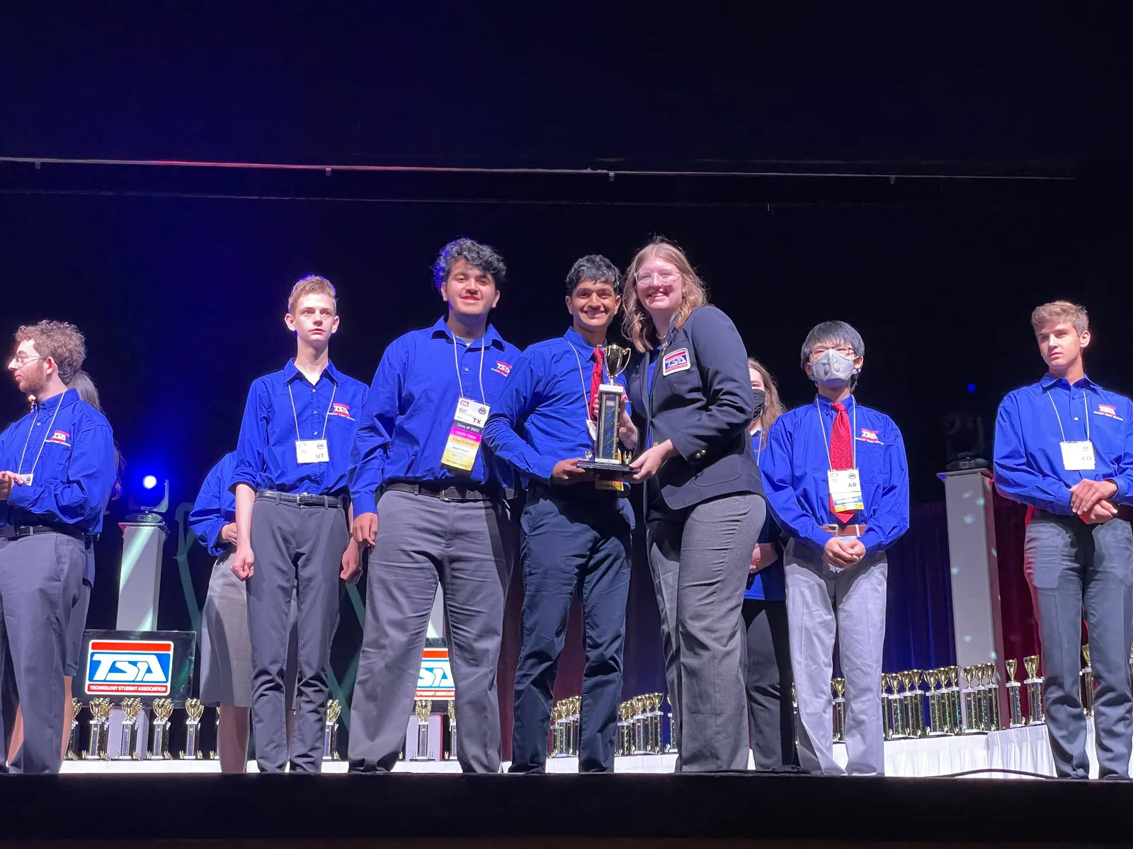 Members receiving a trophy on the awards stage