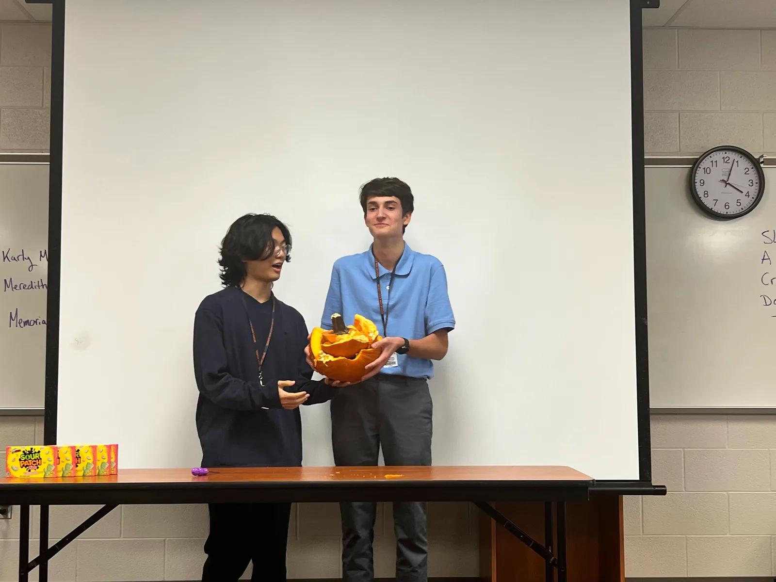 Members holding their carved pumpkin together