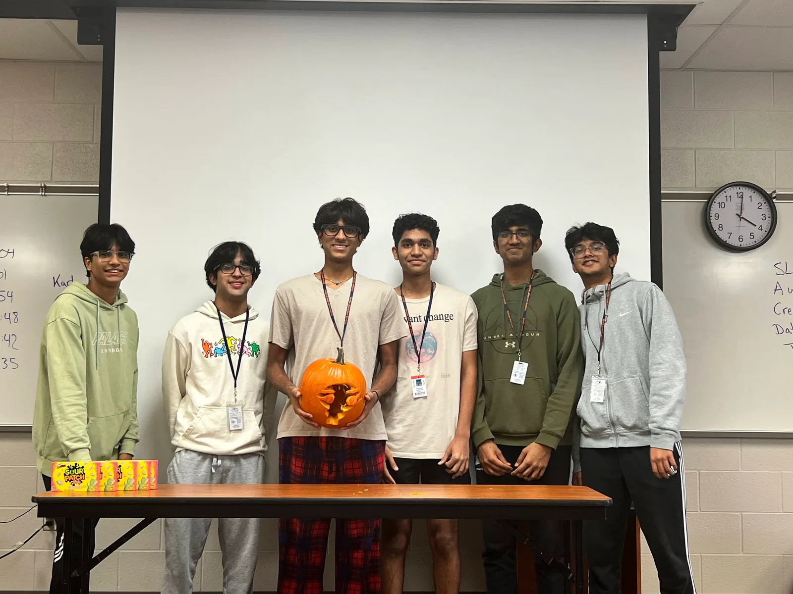 Six members with their carved pumpkin at the fall social