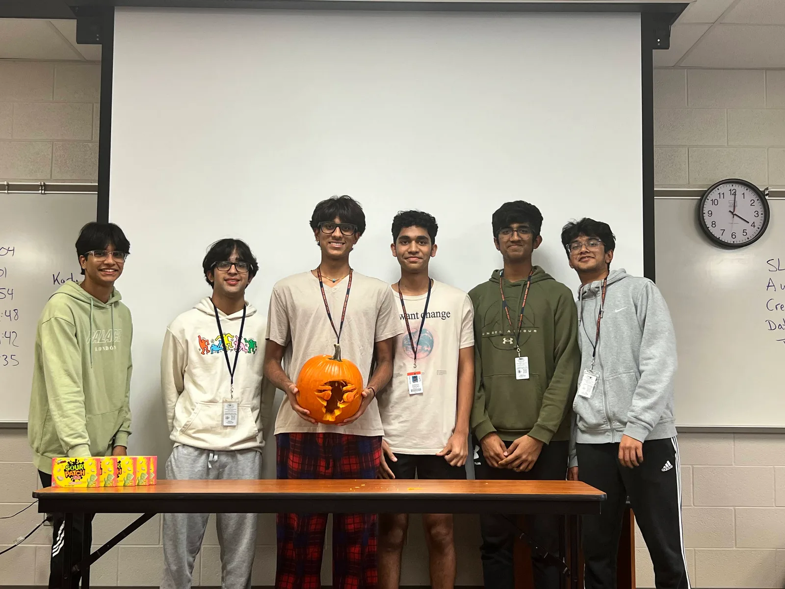 Team presenting their carved pumpkin design