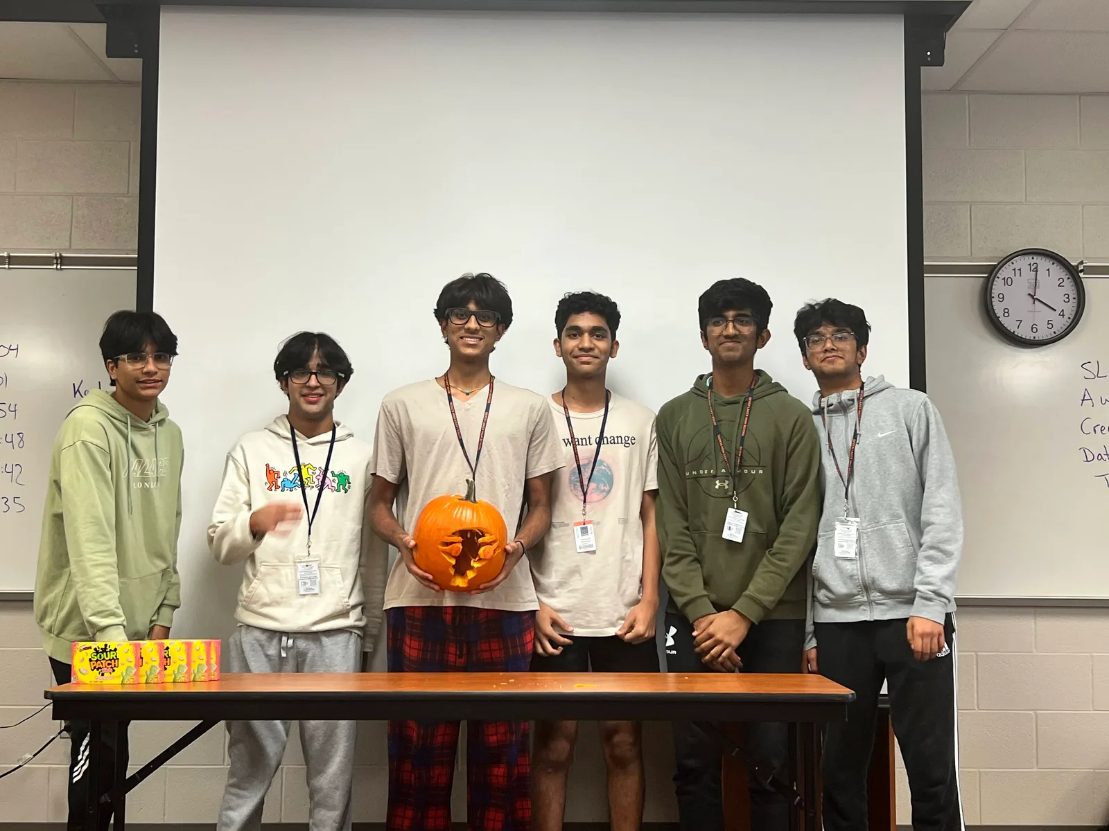 Members displaying the finished pumpkin carving