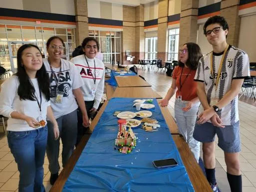 Members lined up along the build table at the winter social