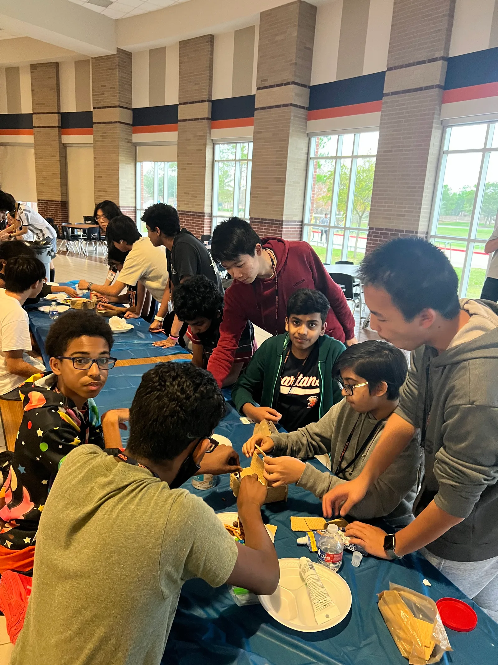 Members crowding the table to work on candy builds
