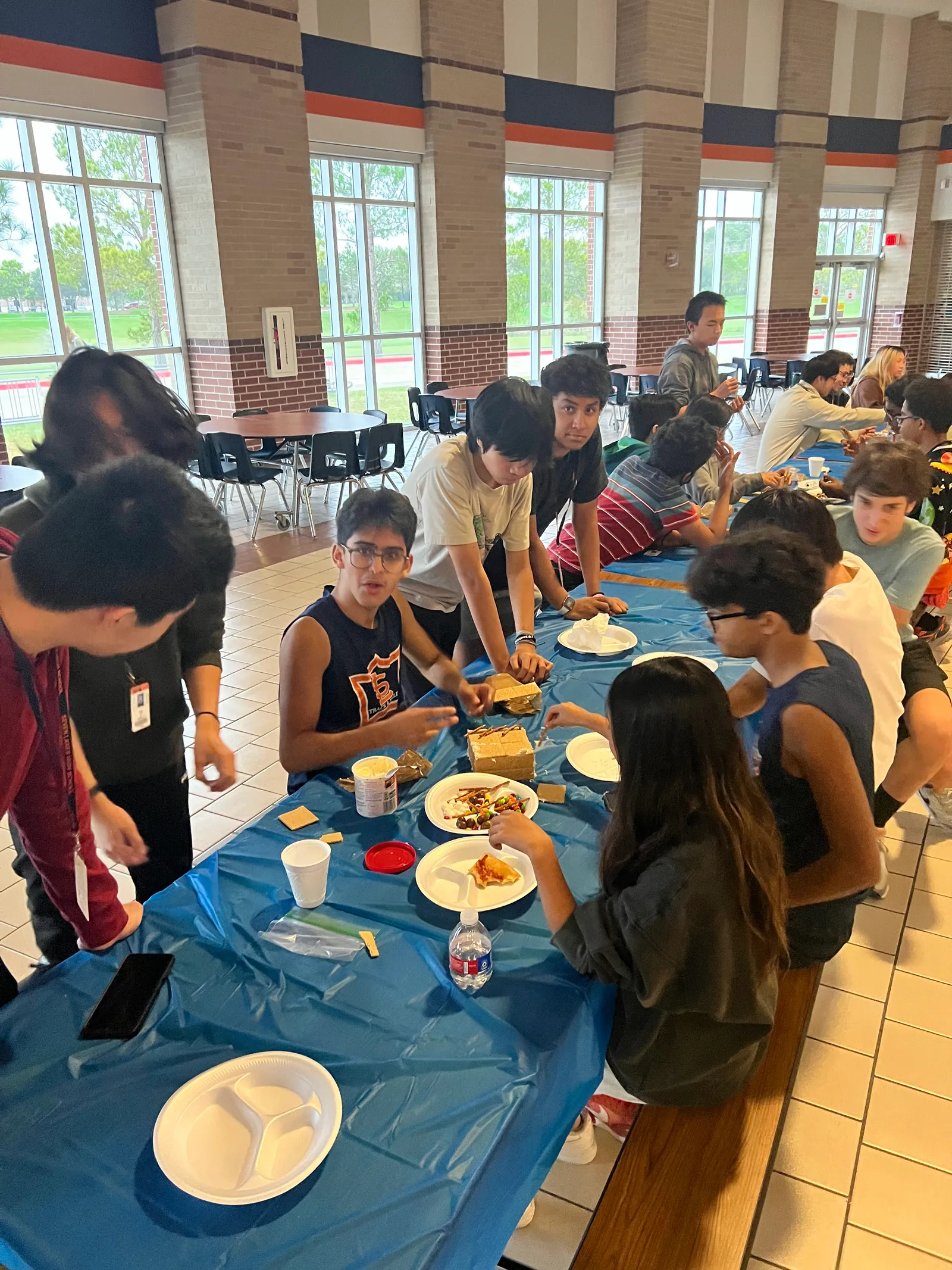Members building along the long cafeteria tables