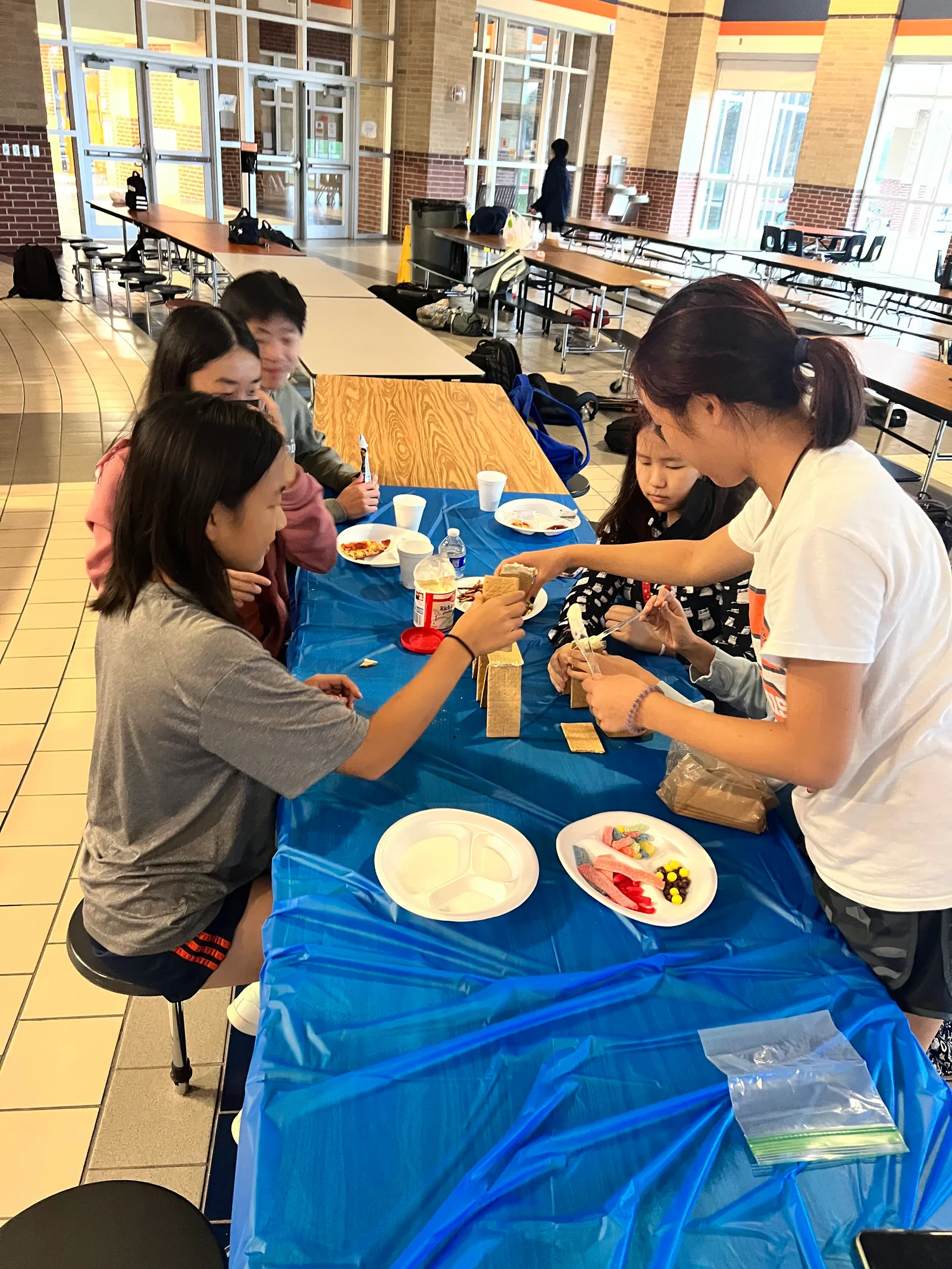 Members leaning in to finish their candy build
