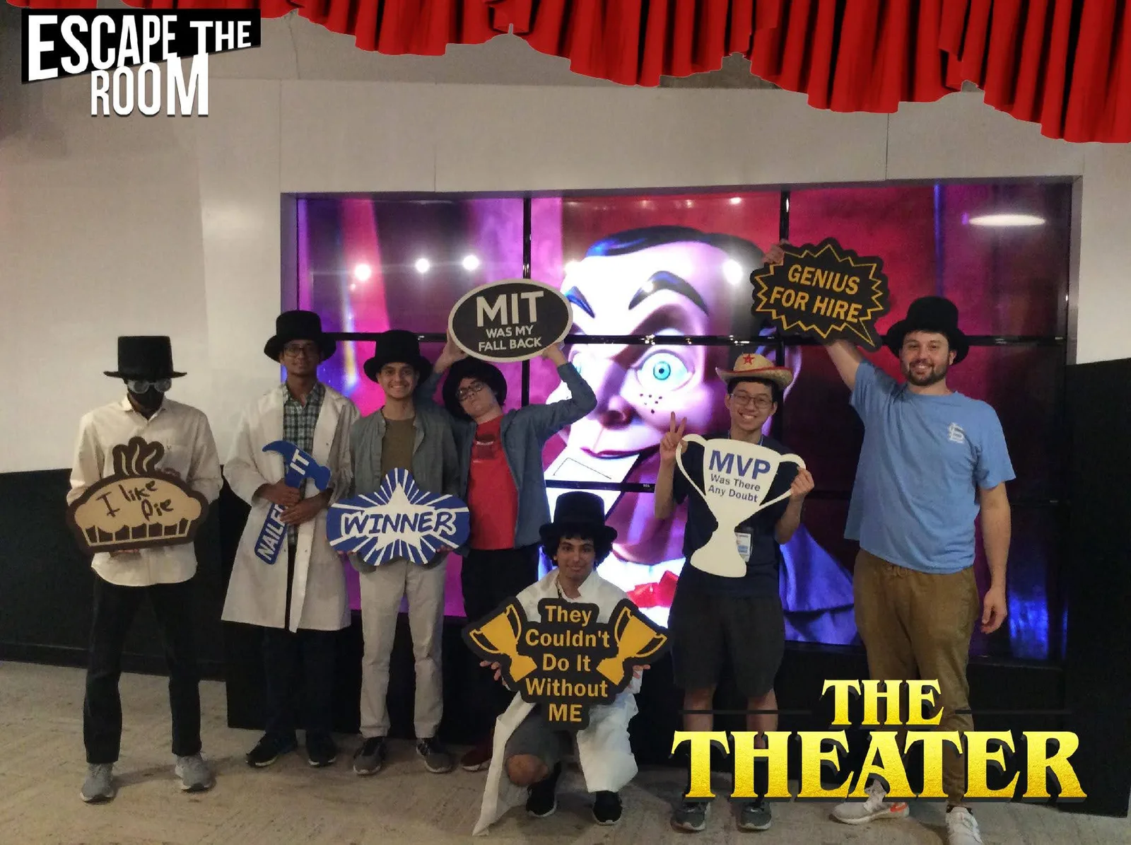 Group photo with props after beating the Escape The Room theater