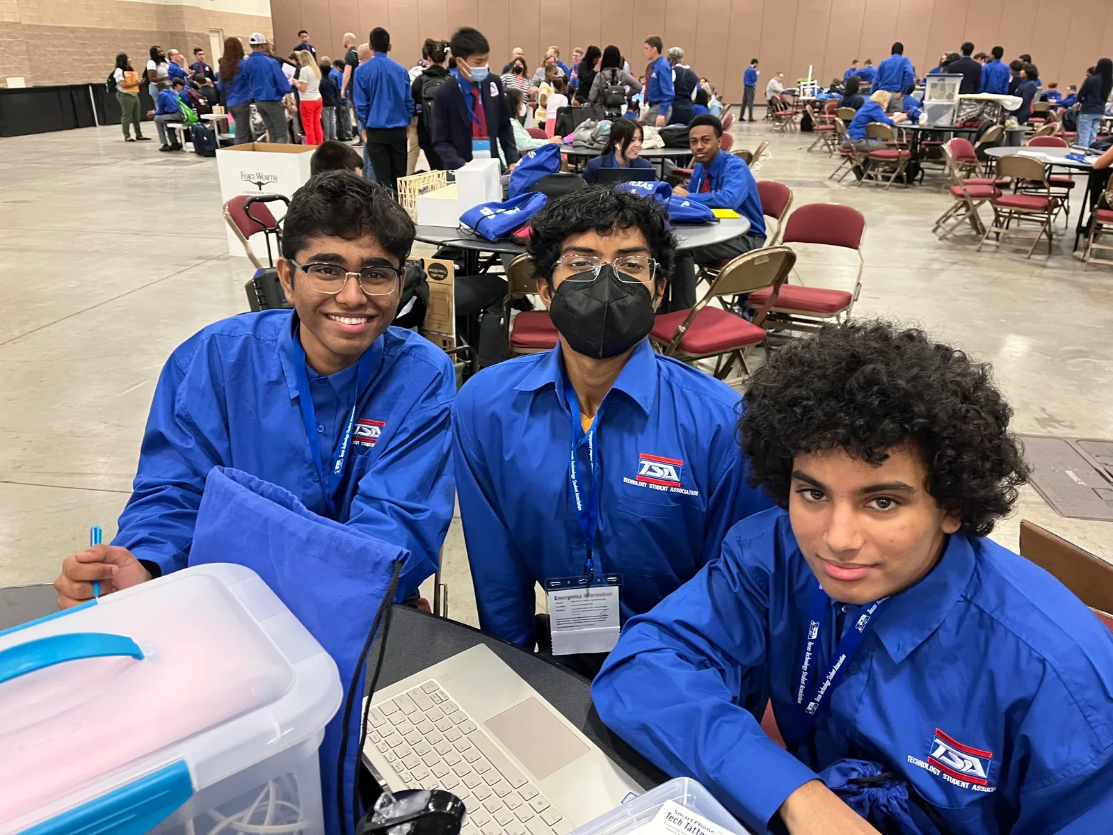 Members in blue TSA shirts at their table on the conference floor