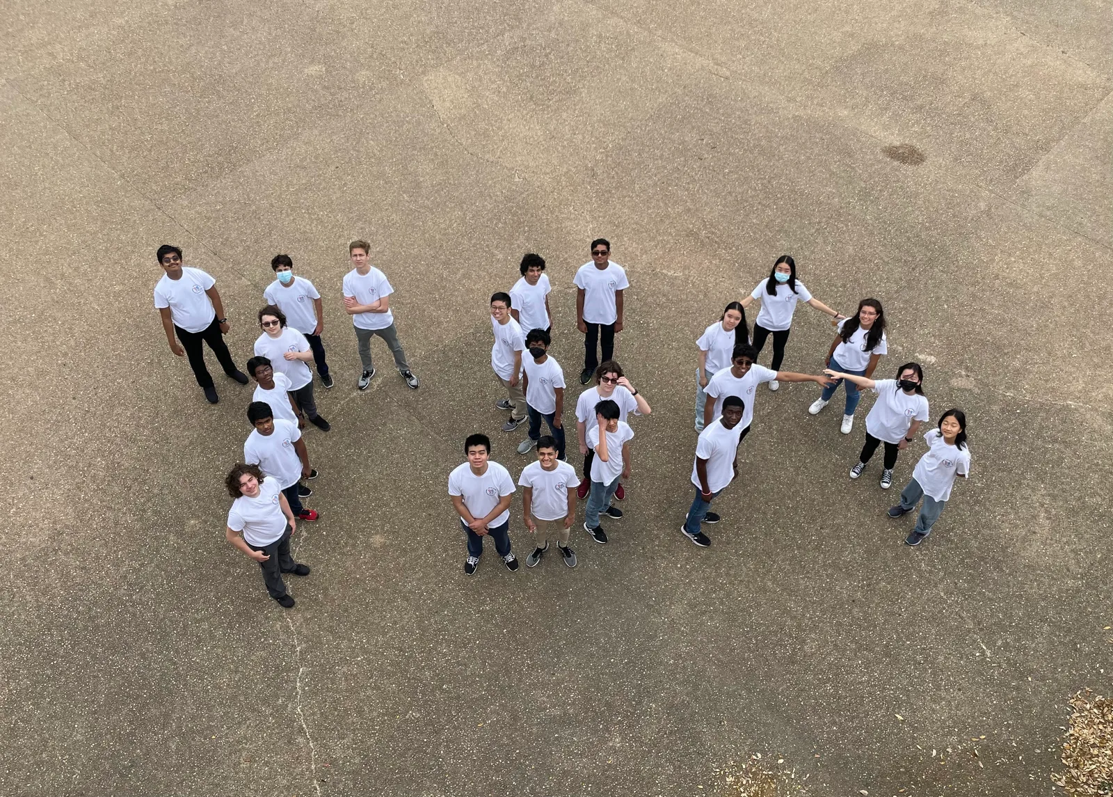 Aerial shot of members arranged in formation on the pavement