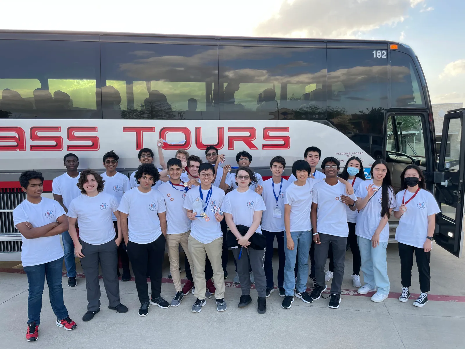 Chapter group photo in front of the First Class Tours bus