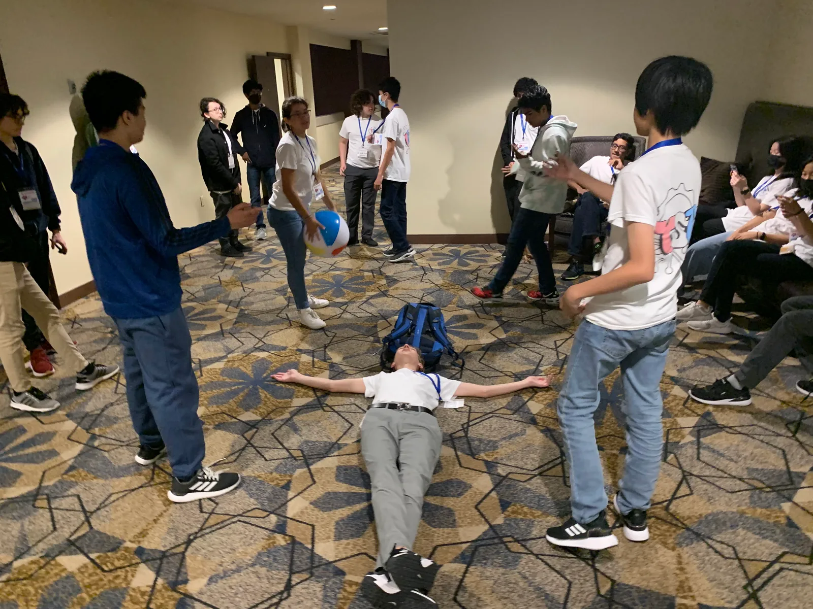 Members playing with a beach ball in the hotel hallway