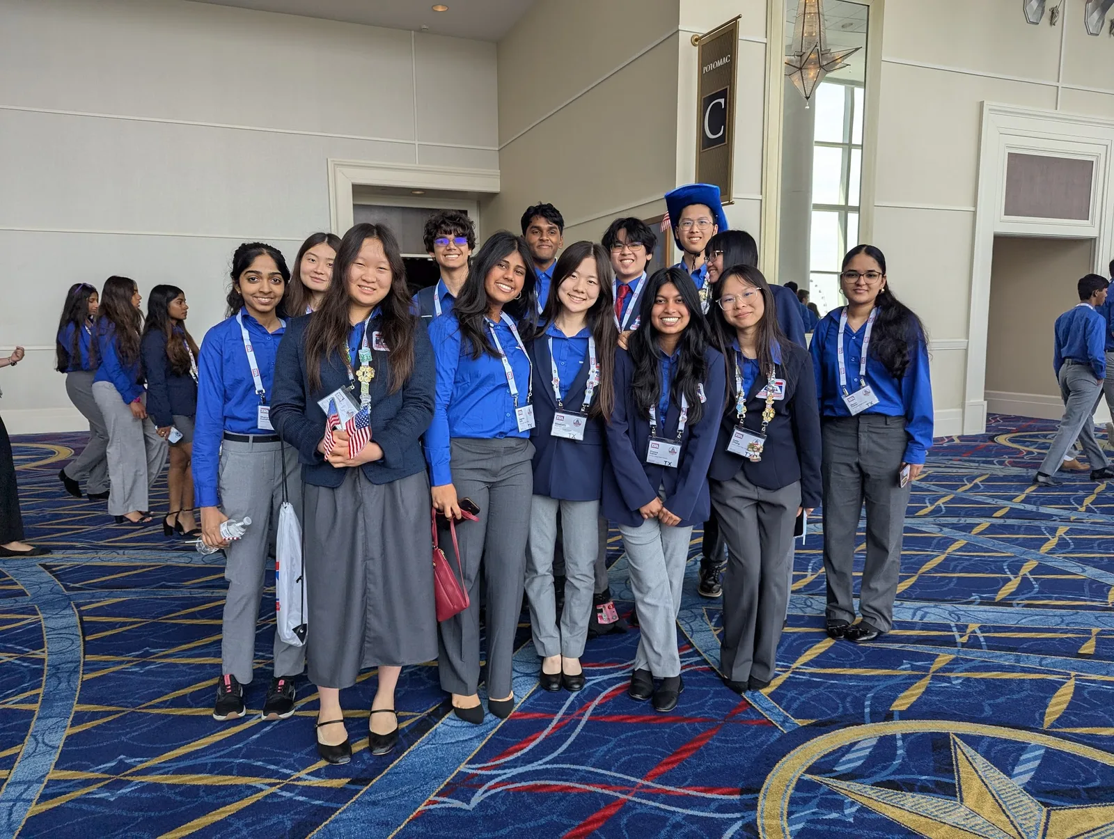 The full SLHS TSA delegation in blue competition shirts gathered in the convention center hallway