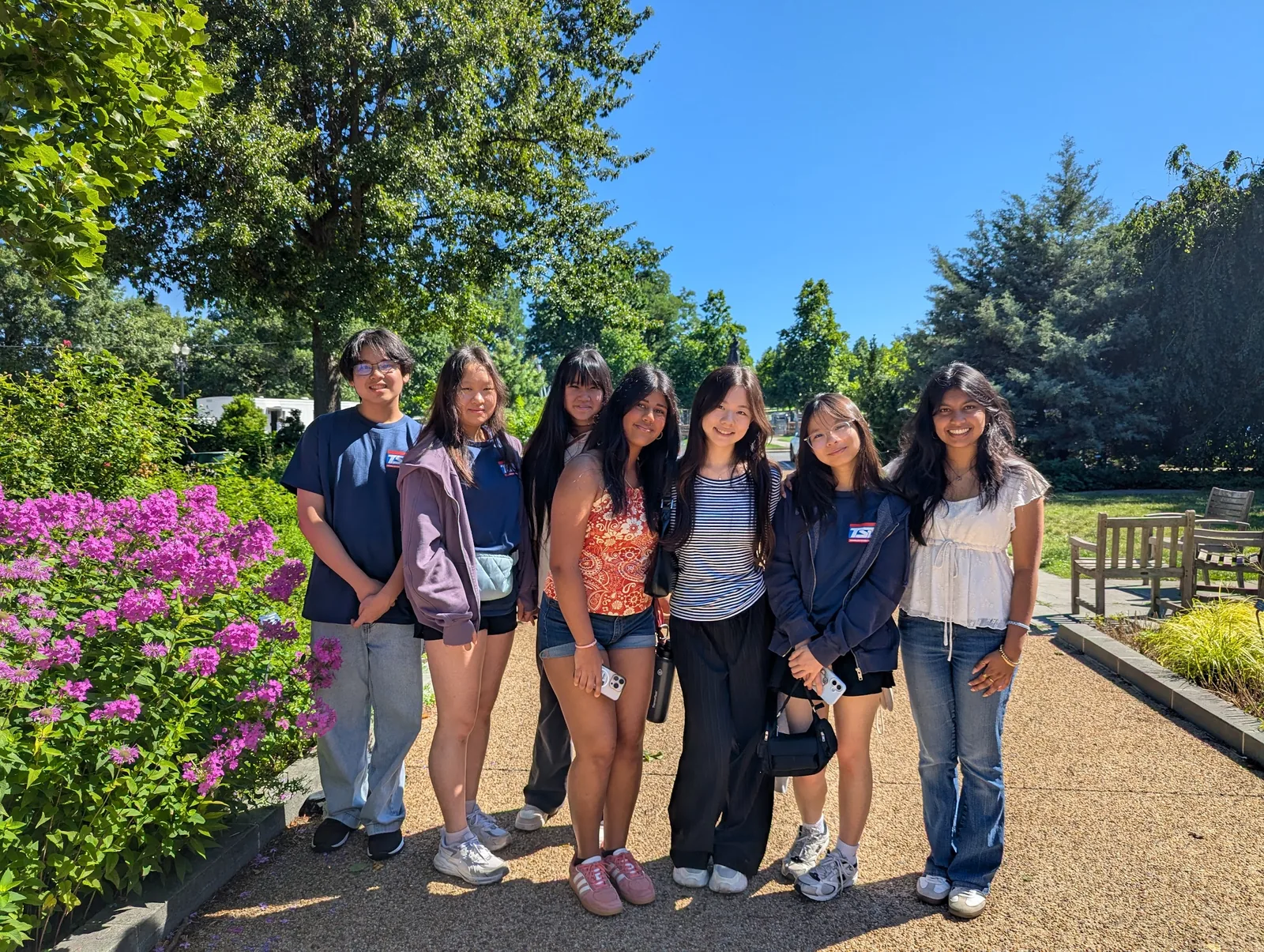 The SLHS TSA delegation gathered together by blooming flowers and greenery on a sightseeing day at the 2026 National TSA Conference