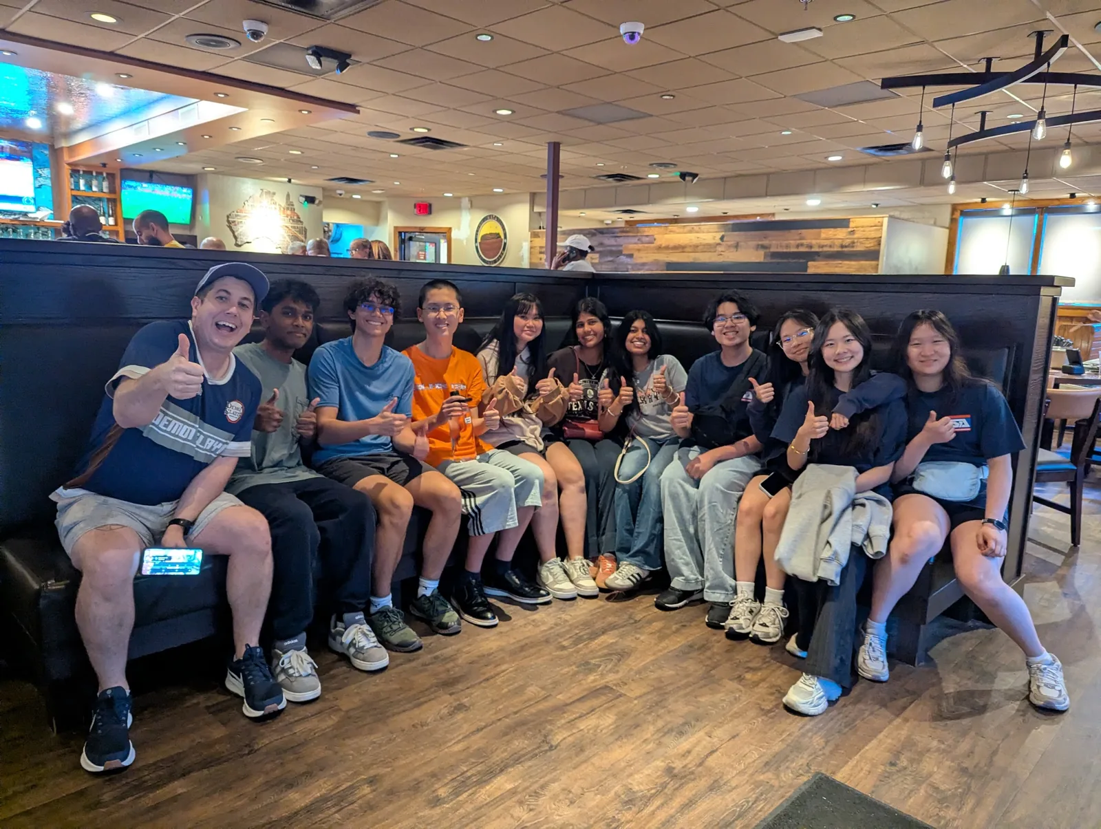 The whole SLHS TSA delegation packed into a big restaurant booth for a team dinner at the 2026 National TSA Conference