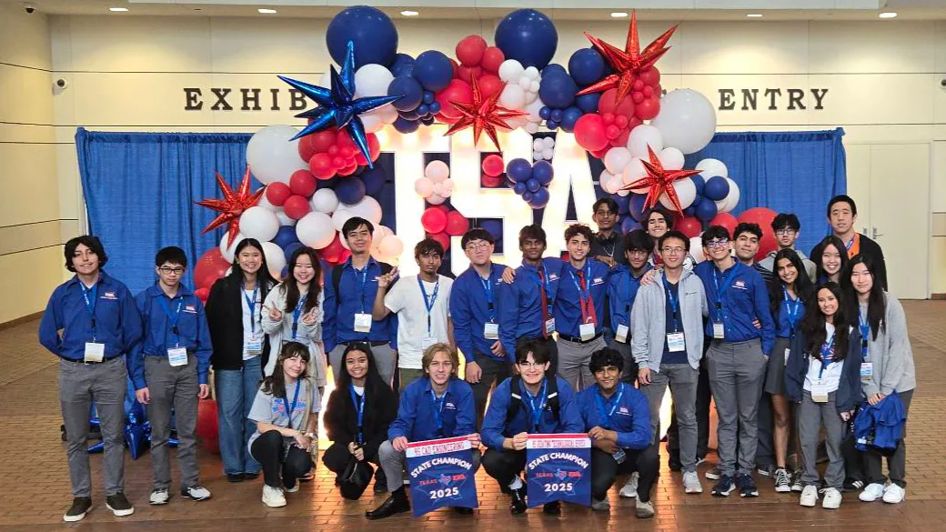 The full SLHS TSA chapter under a balloon arch at Texas TSA State 2025, holding two State Champion banners